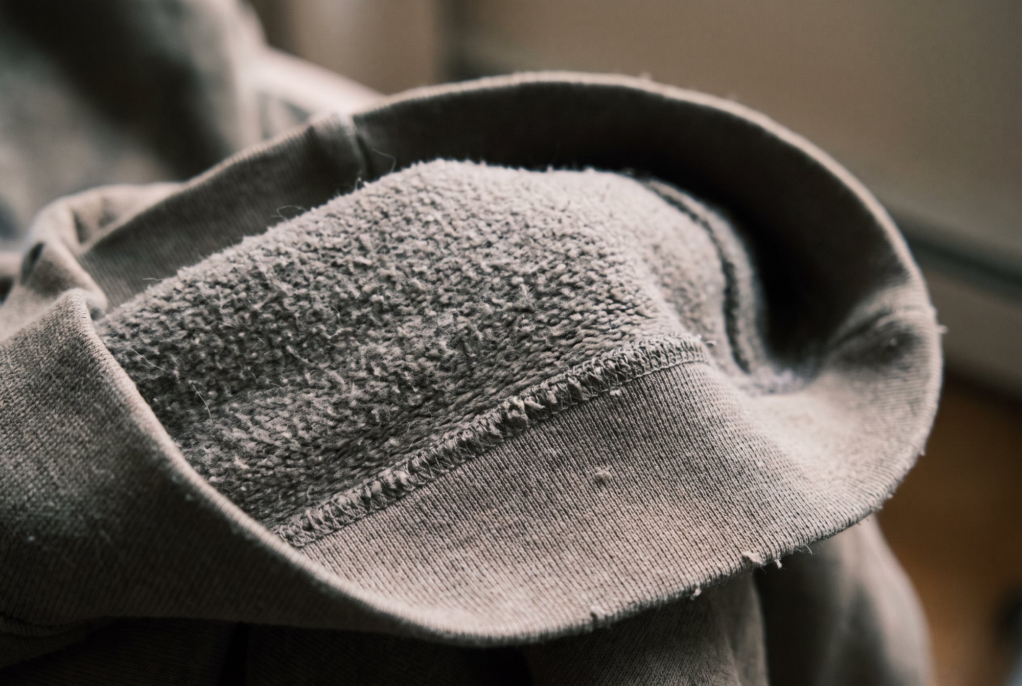 Extreme close-up macro of the soft brushed inside of a grey fleece hoodie