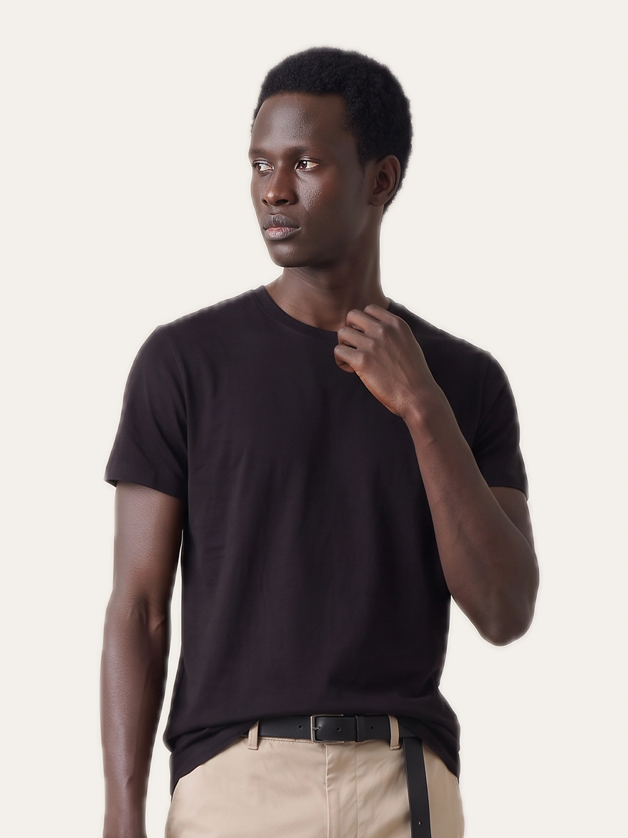 Person wearing the black CORE Crew Tee with trousers