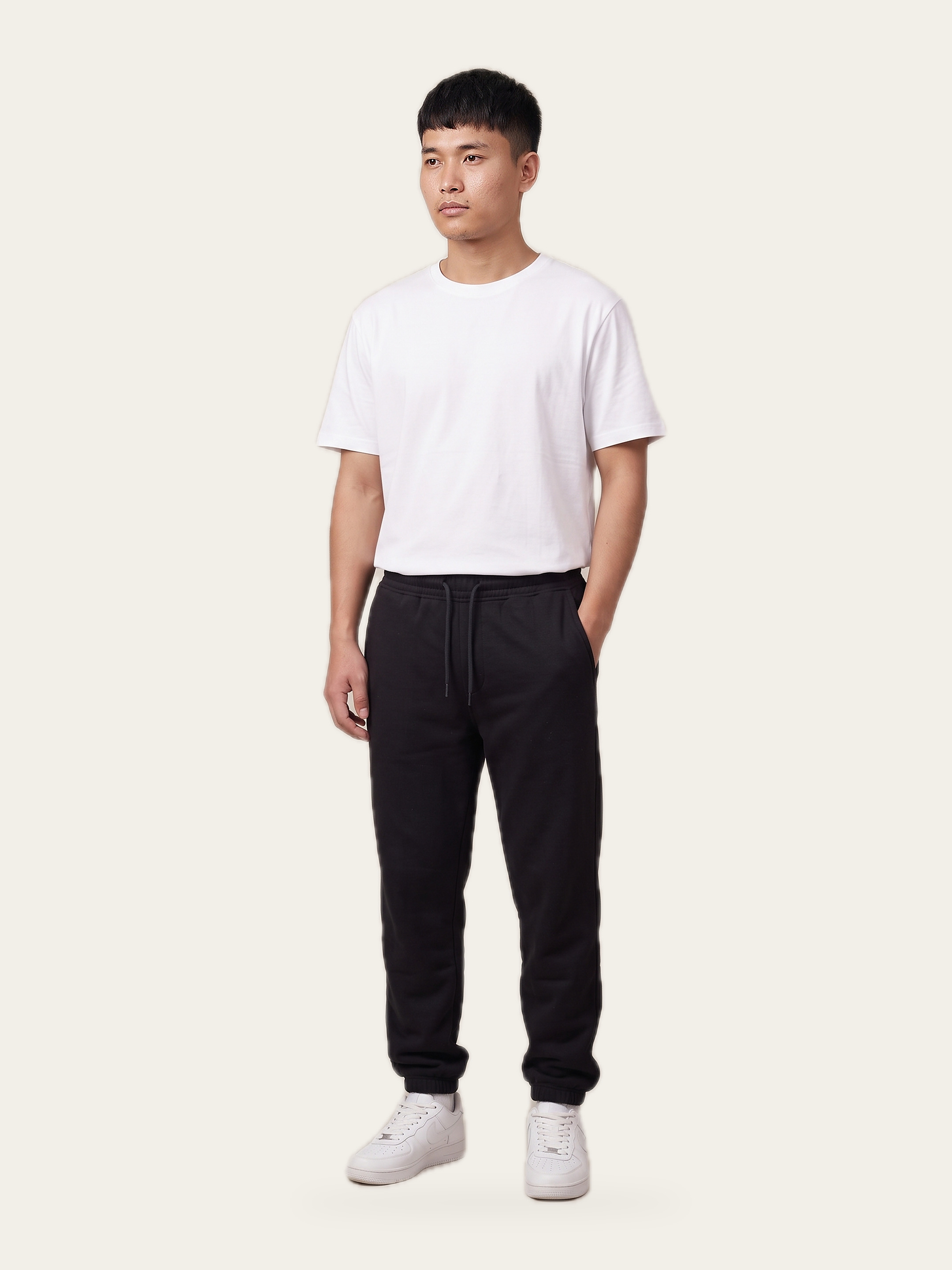 Man wearing black EASE Joggers with a tapered leg and ribbed cuffs