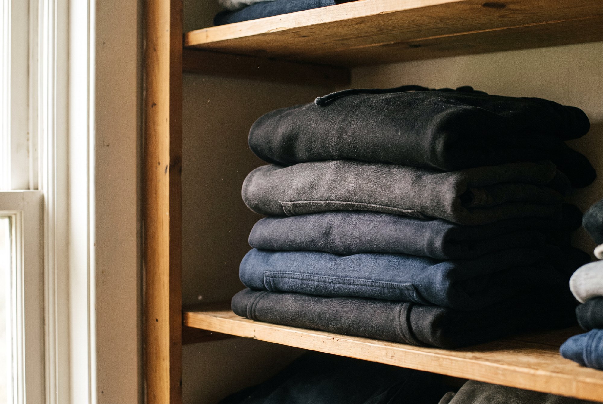 A neat stack of folded hoodies in black
