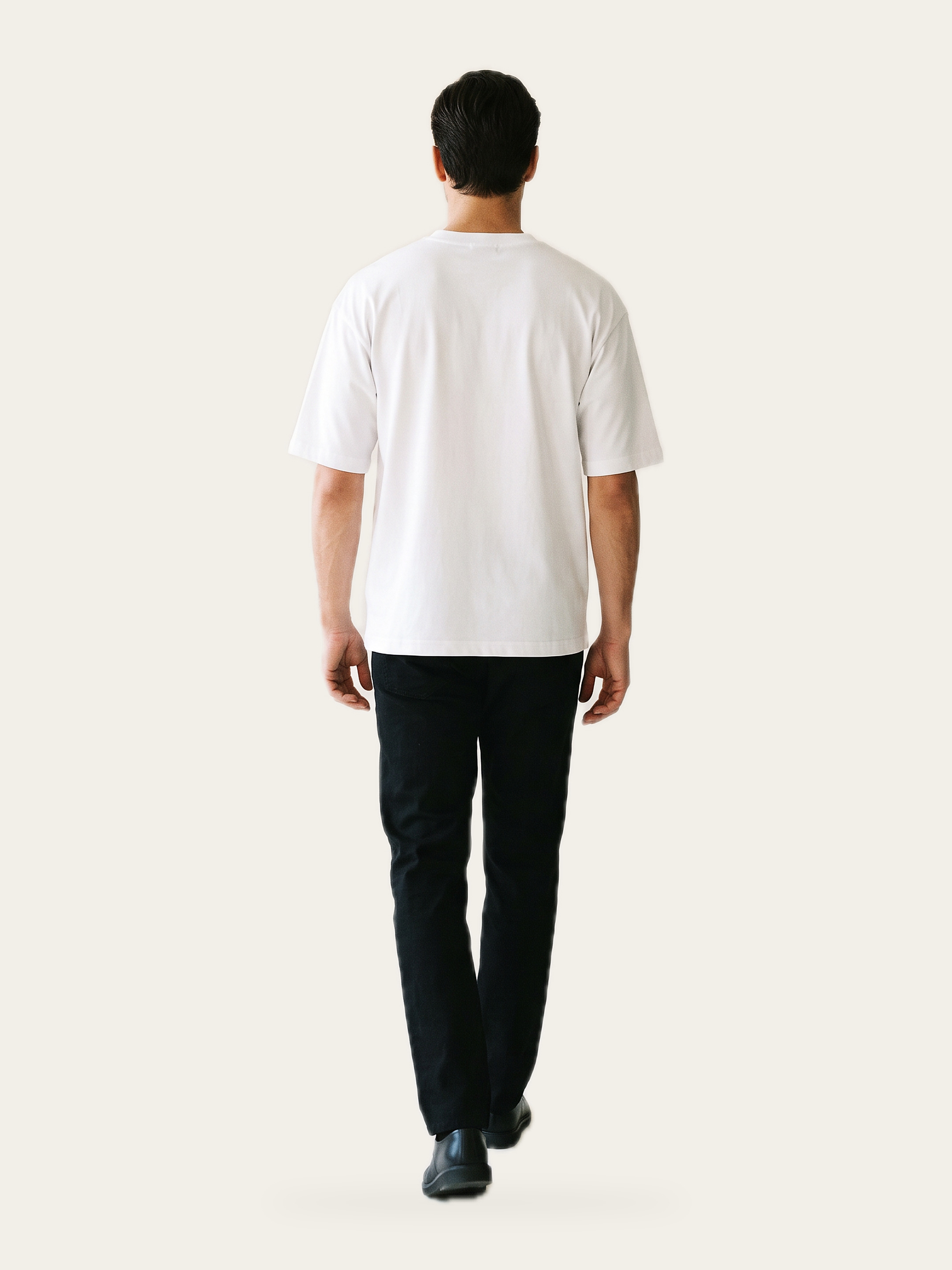 NAKED dot oversized tee in Rui White, back view, worn with black trousers