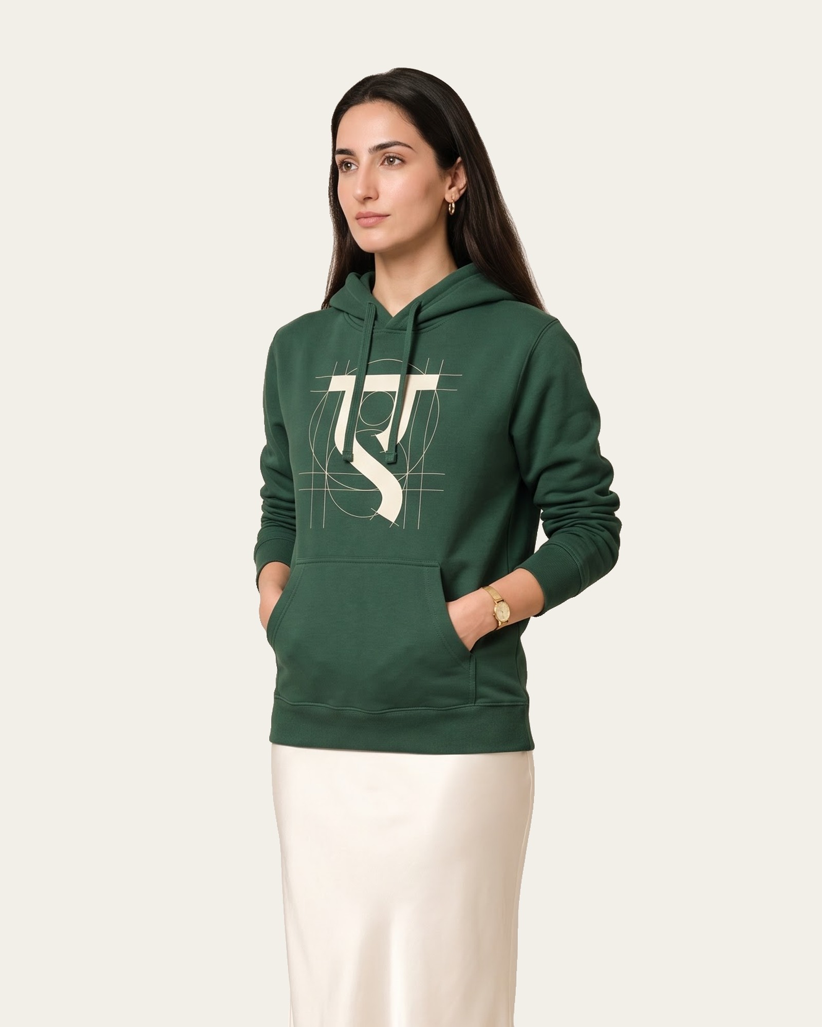 AKSHAR hoodie in Arav Green, worn with a cream skirt